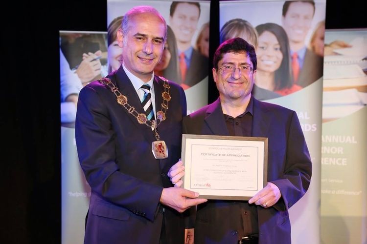 Dr Andrew Sergis receiving an award